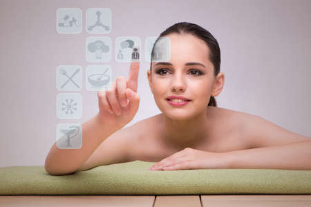 Woman in spa pressing buttonsの写真素材