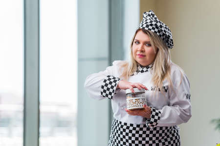 Woman cook working in the bright kitchenの写真素材