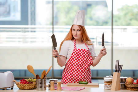 Redhead cook working in the kitchenの写真素材