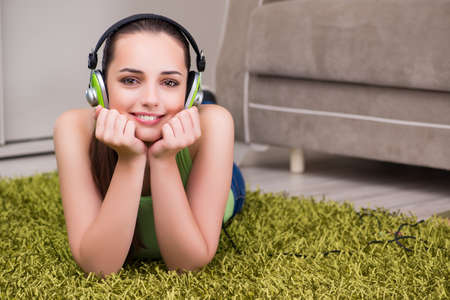 Young woman listening to music at homeの写真素材