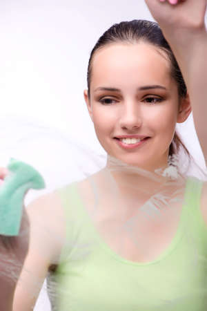 Young housewife in cleaning conceptの写真素材