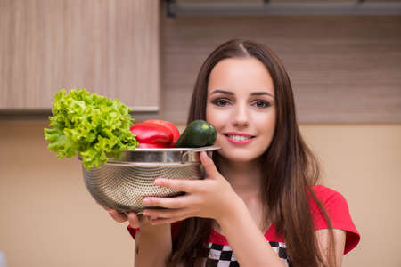 Young woman housewife working in the kitchenの写真素材