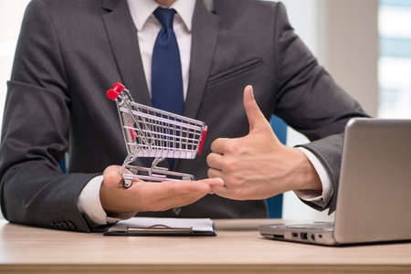 Businesswoman with shopping cart trolleyの写真素材