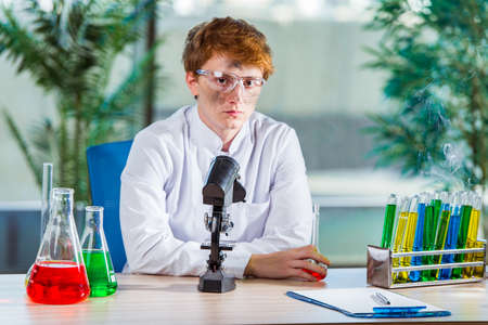 Young crazy chemist working in the lab