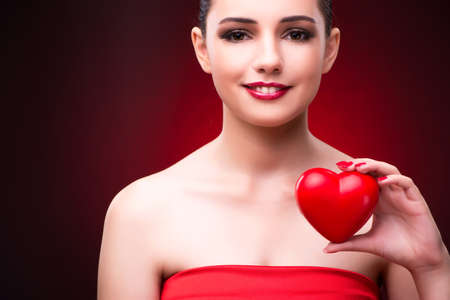 Woman with red heart in romantic conceptの写真素材