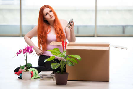 Young woman moving house in lifestyle conceptの写真素材