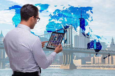 Businessman with tablet in global business conceptの写真素材