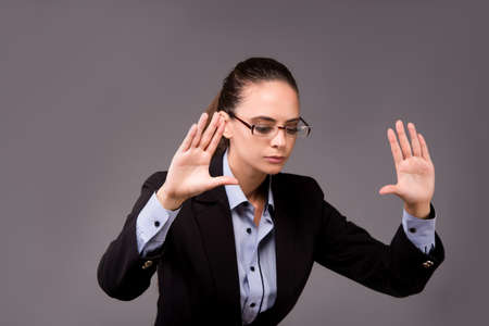 Young woman businesswoman pressing virtual buttonsの写真素材