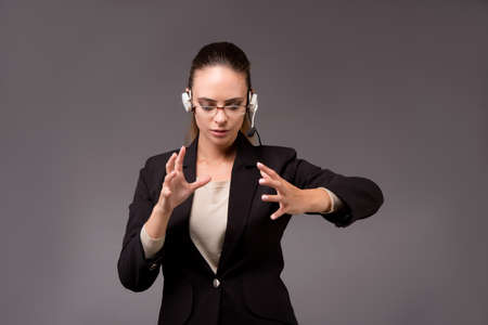 Young woman businesswoman pressing virtual buttonsの写真素材