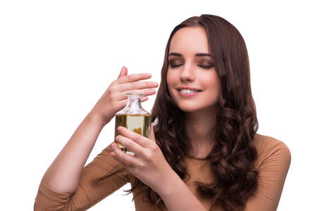 Young woman with perfume bottle isolated on whiteの写真素材