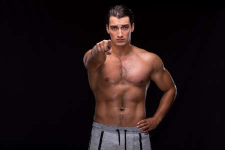 Ripped muscular man on black backgroundの写真素材