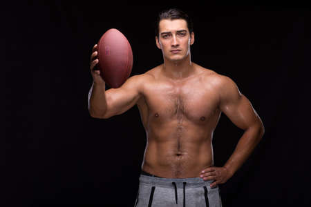 Ripped muscular man with american footballの写真素材
