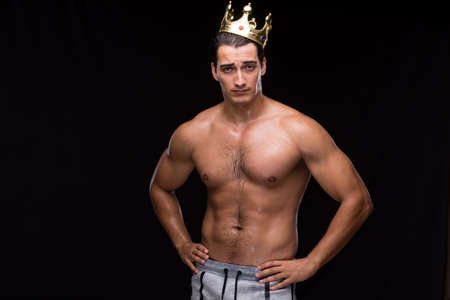 Ripped muscular man with king crownの写真素材