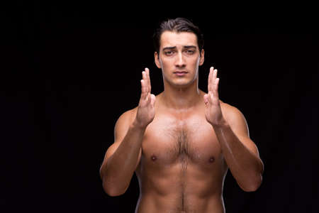 Ripped muscular man pressing virtual buttonsの写真素材