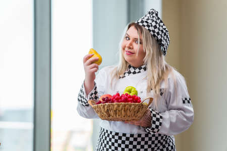 Woman cook working in the bright kitchenの写真素材