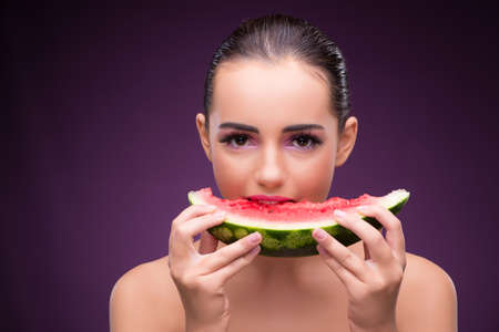 Beautiful woman eating tasty watermelonの写真素材