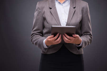 Woman with tablet computer in business conceptの写真素材