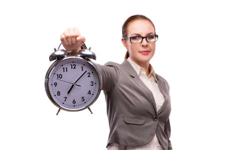Businesswoman with giant alarm clock isolated on whiteの写真素材