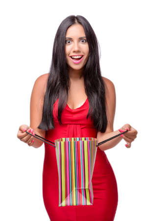 Woman in red dres after shopping isolated on whiteの写真素材