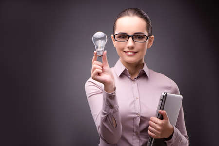 Businesswoman with lightbulb in business conceptの写真素材