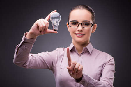 Businesswoman with lightbulb in business conceptの写真素材