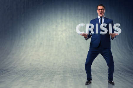 Man struggling with crisis in business conceptの写真素材