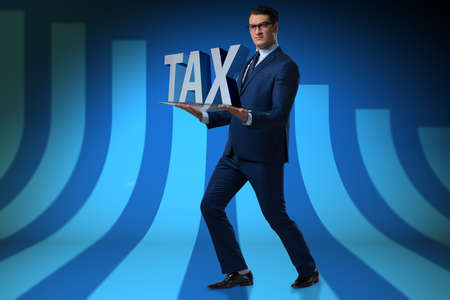 Businessman struggling with high taxesの写真素材