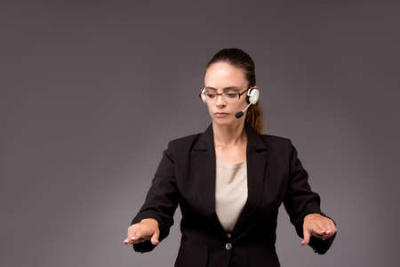 Young woman businesswoman pressing virtual buttonsの写真素材