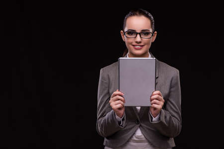 Young woman with tablet in business conceptの写真素材