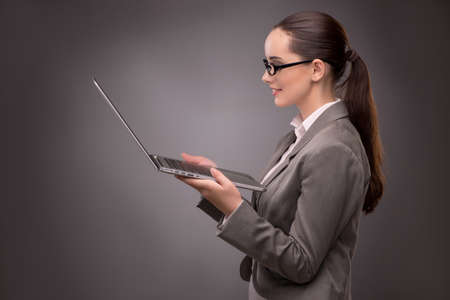 Young businesswoman working with laptop in business conceptの写真素材