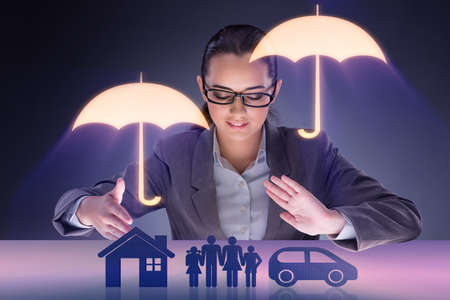 Young businesswoman in insurance conceptの写真素材