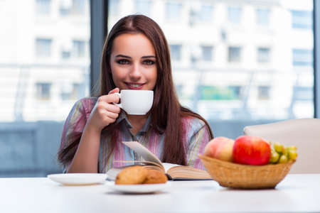Young girl having breakfast on the morningの写真素材