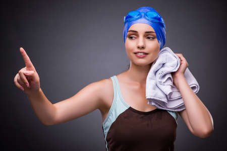 Woman swimmer against grey backgroundの写真素材