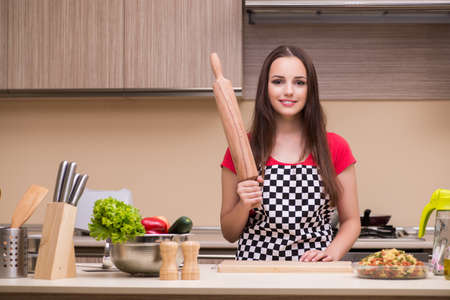 Young woman housewife working in the kitchenの写真素材