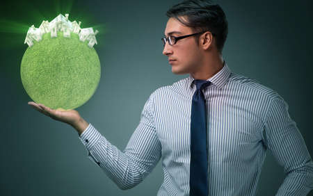 Young handsome businessman in mortgage conceptの写真素材