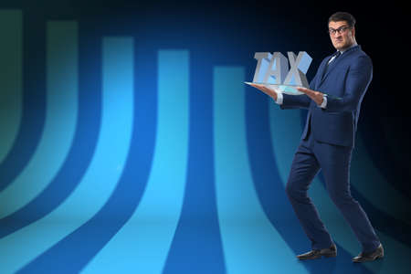 Businessman struggling with high taxesの写真素材