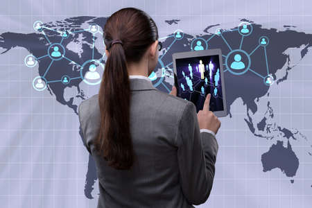 Young businesswoman in social networks conceptの写真素材