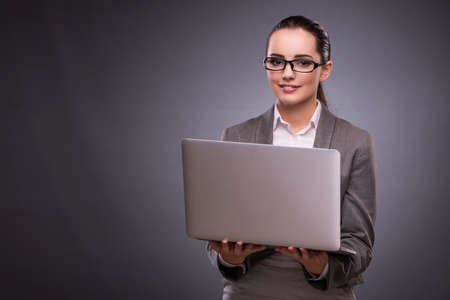 Businesswoman with laptop in business conceptの写真素材