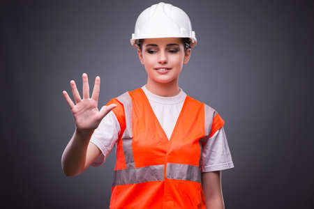 Cute construction worker pressing virtual buttonsの写真素材