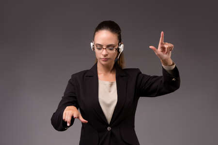 Young woman businesswoman pressing virtual buttonsの写真素材