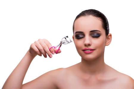 Woman with eyelash curler isolated on white