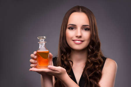 Young woman with bottle of perfume
