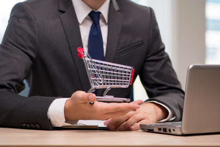 Businesswoman with shopping cart trolleyの写真素材