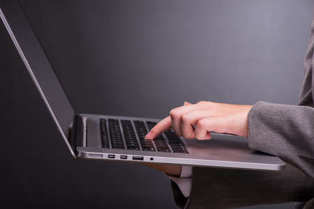 Businesswoman with laptop in business conceptの写真素材