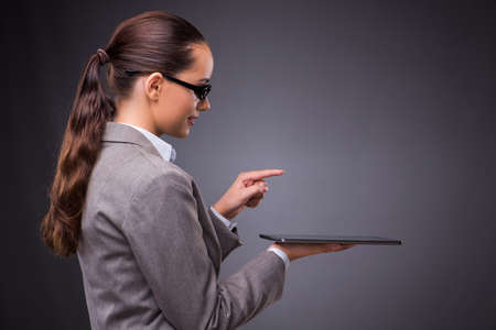 Woman with tablet computer in business conceptの写真素材