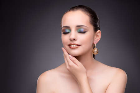 Beautiful woman showing off her jewellery in fashion conceptの写真素材