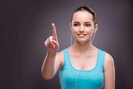 Woman in sports concept pressing buttonsの写真素材