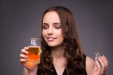 Young woman with bottle of perfumeの写真素材