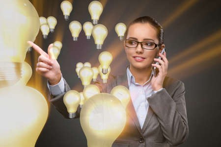 Woman with light bulb in idea conceptの写真素材