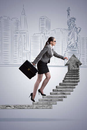 Businesswoman climbing career ladder conceptの写真素材